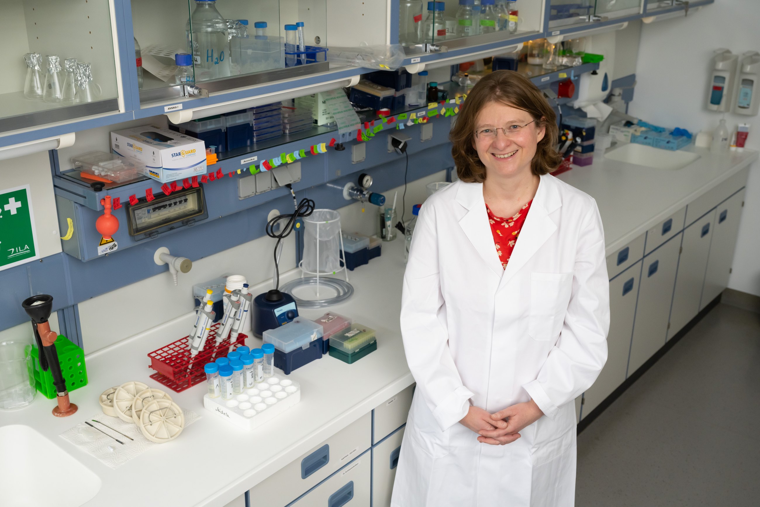 Researcher standing in a laboratory with sample preparation equipment